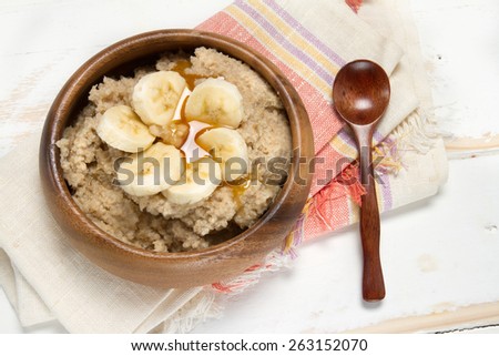 Healthy breakfast: oat bran porridge, banana and agave syrup