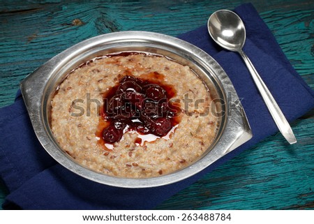 Oat bran and flax seeds porridge with gooseberry jam