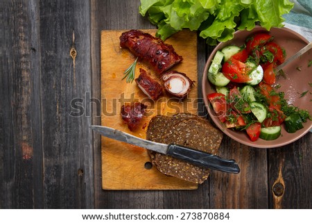 Roasted saddle of rabbit wrapped in bacon, lettuce, tomatoes, cucumbers, dill and whole wheat bread
