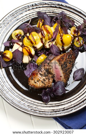 Grilled tuna with spicy mozzarella, purple basil and yellow mini tomatoes salad