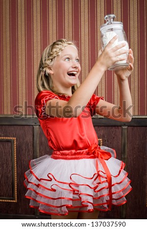 Portrait of a girl in a red packet of sweets in the bank