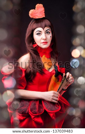 portrait of a cute queen of hearts on the black background