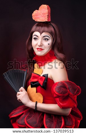 portrait of a cute queen of hearts on the dark background