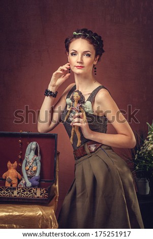 Portrait of a beautiful woman with a handmade doll