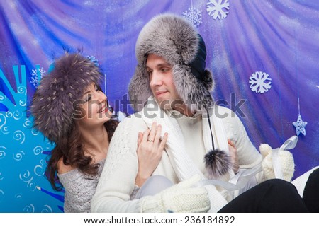 Happy family in winter hat, gloves and sweater on sled