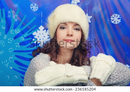 Woman in warm gloves on a blue background