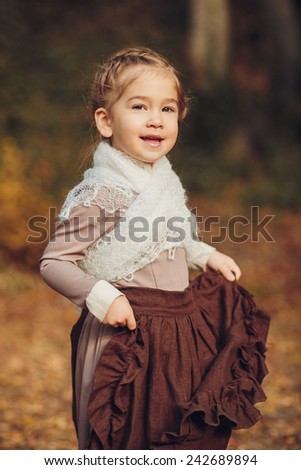 Cute girl in vintage clothes in autumn forest
