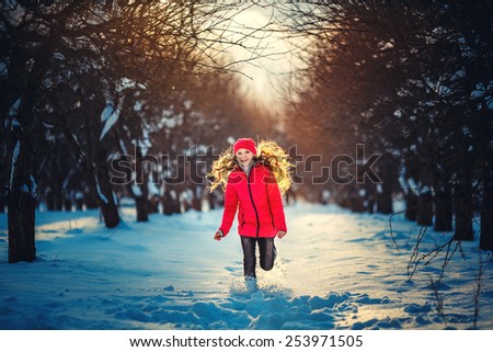 Beauty Teenager Girl Running in frosty winter Park. Outdoors. Sunny day. Backlit.
