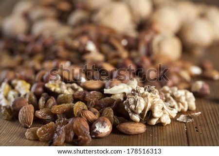 mixed nuts raisins walnuts almonds on wood