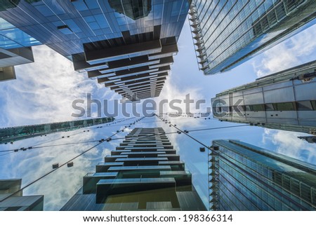 LONDON, UK - JUNE 08, 2014: Upward view of  modern skyscrapers in the City of London, UK. The City is a major business and financial centre. Over 300,000 people commute to and work there.