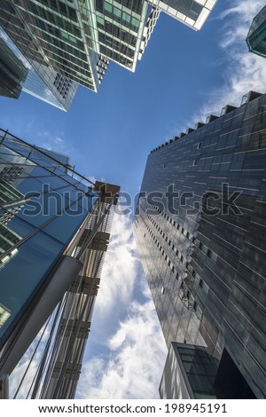 LONDON, UK - JUNE 08, 2014: Upward view of  modern skyscrapers in the City of London, the heart of financial district in London. Over 300,000 people work there, mainly in the financial services sector