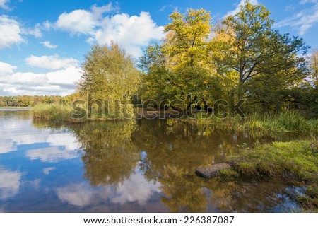 A lake in the park with colorful autumn tree reflections