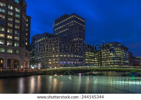LONDON, UK - JANUARY 11, 2015: Night view of Canary Wharf, a major business district located in London, UK. It's a home to the headquarters of numerous major banks and other professional service firms