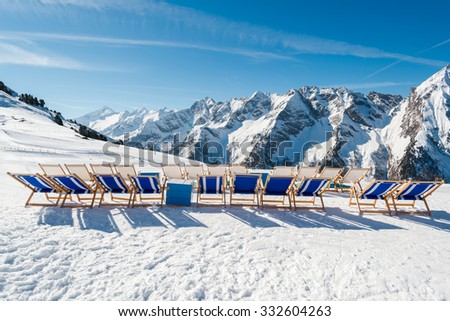 Empty blue deck chairs on the snow in Mayrhofen ski resort, Austrian Alp
