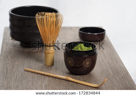 Japanese tea ceremony setting on old wooden bench. Studio photo. Green tea utensils.