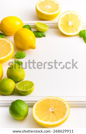 Fresh lime and lemon citrus fruits on white background. Copy paste your own text. Empty space next to yellow and green juicy fresh fruits on white bakground.