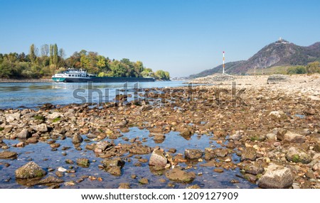 Inland navigation vessel with reduced shipload on dried out river Rhine with low water level, caused by prolonged drought 2018, by Bad Honnef and Drachenfels, North Rhine-Westphalia, Germany, Europe