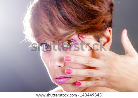 Portrait of a young woman with hand on face