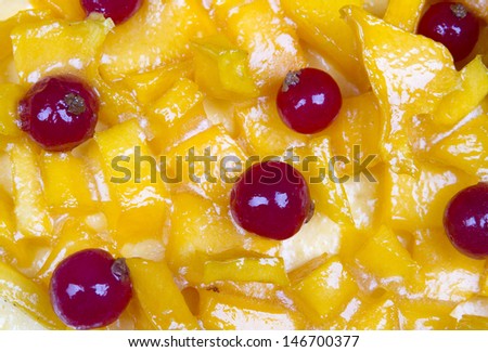 Background with mango cake and red fruits