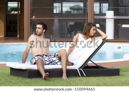 Young beautiful woman and man in a swimming pool