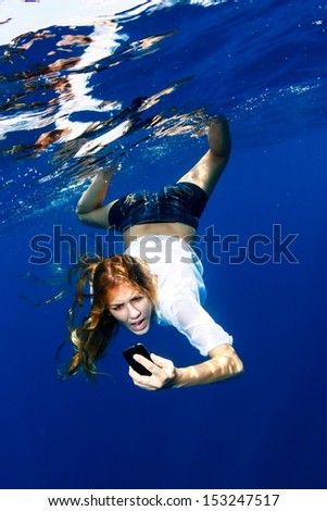 Woman yelling at phone in water