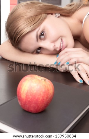 Young girl happy relaxed looking an apple and book