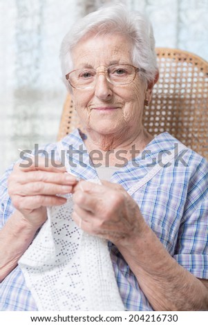 old woman doing crocheting, close up