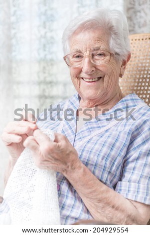 old woman doing crocheting, close up