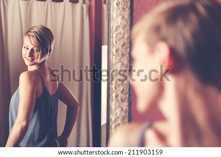 woman trying on clothes and in a clothing store