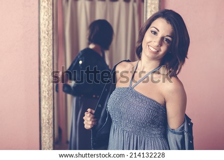 woman trying on clothes and shopping in a clothing store