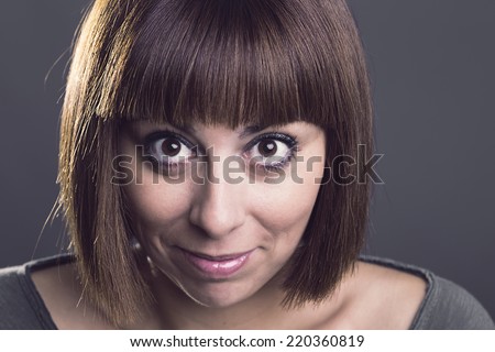 Portrait of a normal girl looking camera and beautiful woman portrait over grey background