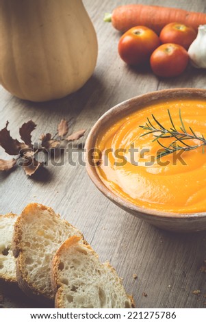 Pumpkin Soup prepared for autumn with chicken broth, spices, other vegetables, and bread