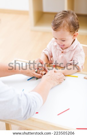 Cute little boy playing with numbers and sticks at the nursery school