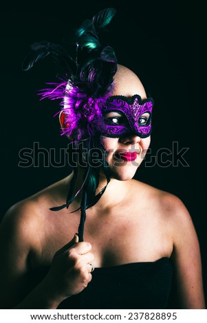 woman in masquerade mask at black background