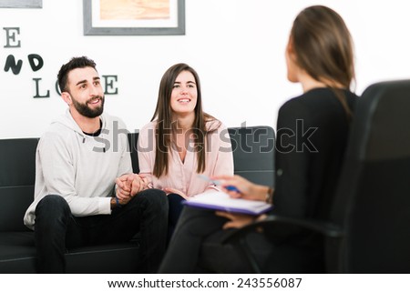 Female psychologist making notes during psychological therapy session