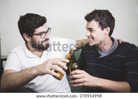 friends with pizza and bottles of drinks at apartment student