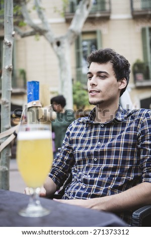 Real man drinking beer on a terrace of barcelona
