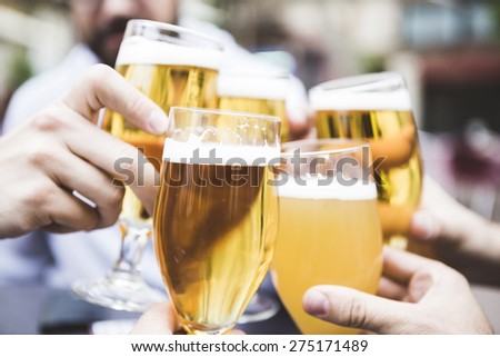 Group of friends toasting with beer for the next successes