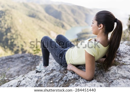 young woman on top of a mountain with good views