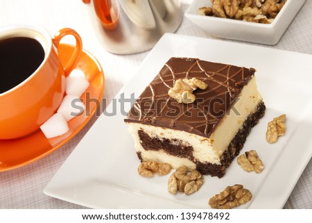 Cheesecak with a cap of coffee with nuts(Selective Focus, Focus on the front upper edge of the cake)