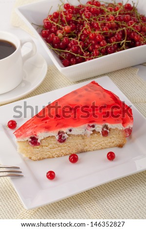homemade cake with jelly, whipped cream and fresh redcurrant