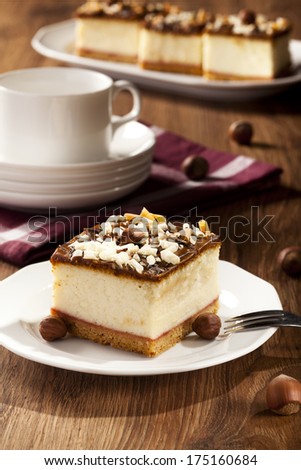 cheesecake with nuts on plate, dark background, selective focus