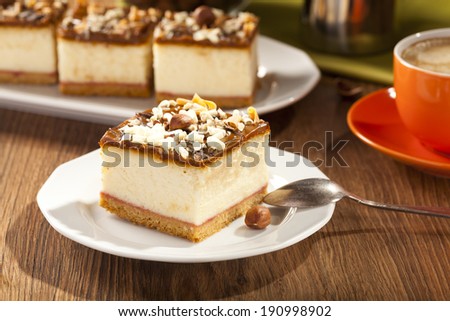 cheesecake with nuts on plate, dark background, selective focus