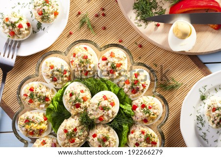 stuffed eggs with ham, red pepper and dill on plate
