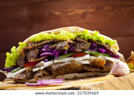 Beef Kebab in a bun on woodboard