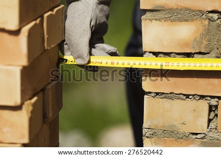 Measuring the wall during construction