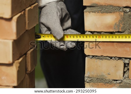 Measuring the wall during construction