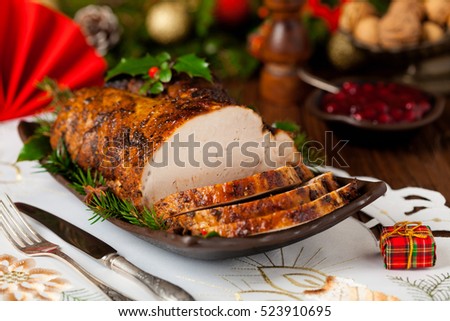 Roast pork loin with Christmas decoration. Front view.