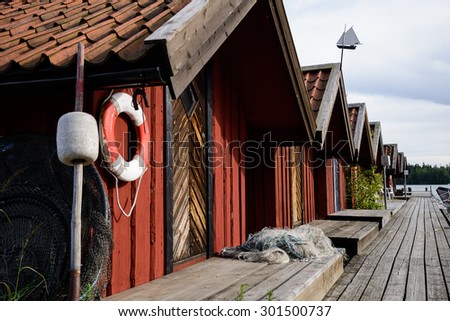 29.07.2015 - Rafsnas, Sweden - Old boat houses sit along the harbor in Rafsnas, Sweden