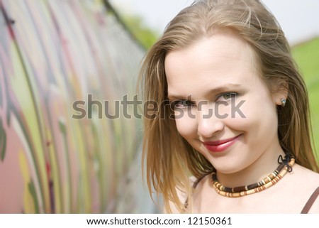 Young Lady Near The Graffiti Painted Wall